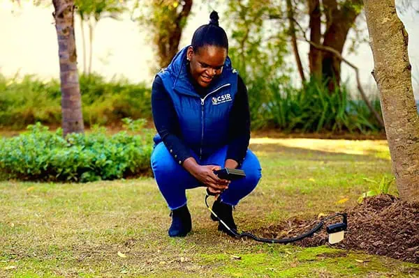 Dr Mpumi Mobe, senior researcher at the CSIR using a handheld HydroSense II system to measure volumetric water content of soil.